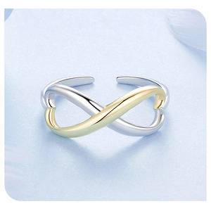 Macro shot of two-tone infinity symbol ring with silver and gold finish detailing