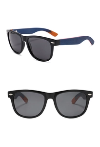 Detail view of oval sunglasses with silver studs and blue-orange wood grain temples