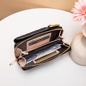 Quilted black leather phone bag with pink interior card slots and gold hardware