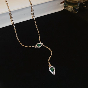 Detail of silver bamboo-style Y-necklace with green pear-shaped diamond pendants