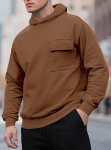Close-up of men's brown fleece hoodie with workwear-style flap chest pocket and knit texture