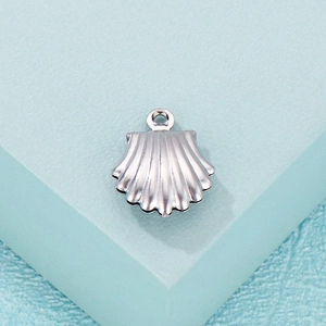 Close-up of a silver-tone shell-shaped pendant with a top loop for DIY jewelry