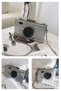 Detail of silver glitter camera bag featuring rhinestone lens and chain strap