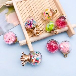DIY colorful star sequins and fruit clay slices in glass globe pendants with gold caps