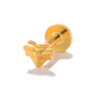 Macro detail of a golden bee stud earring featuring polished S925 sterling silver surface