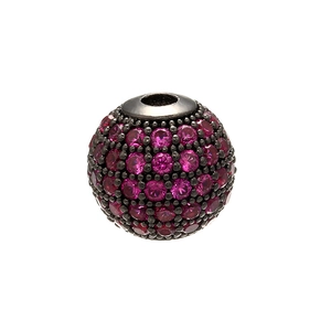 Macro shot of sphere bead with red micro-pave crystals on dark metal for DIY jewelry