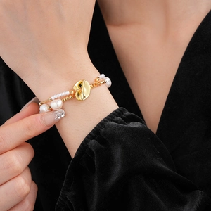 Detail of double-layer freshwater pearl bracelet with gold heart OT toggle clasp