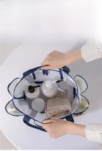 Spacious mesh bag with blue handles showing large opening for toiletries and towels