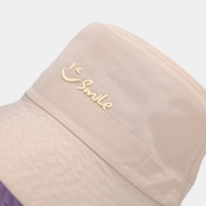 Beige lightweight quick-dry bucket hat with yellow Smile logo and purple trim detail