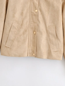 Detail of khaki faux suede jacket showing metal snap buttons and side pockets