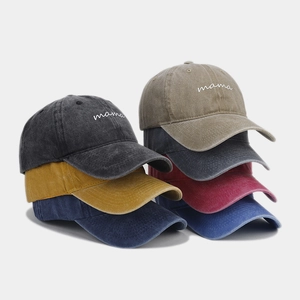 Detail of vintage washed baseball caps with mama embroidery in multiple colors