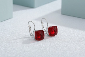 Detailed macro view of square cut red crystal earrings with silver plated finish