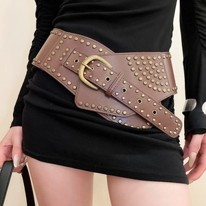 Close-up of vintage brown leather belt with brass studs and an antique gold buckle