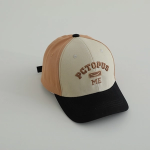 Detailed shot of the tricolor baseball cap showing fine embroidery and cotton texture