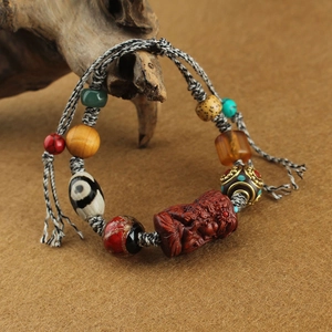 Macro shot of ethnic handmade bracelet with agate beads and ox bone carving detail