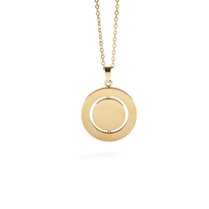 Detailed view of a rotating round gold stainless steel pendant on a minimalist necklace