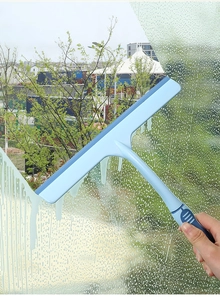 Detail showing non-slip glass squeegee cleaning foamy window surface with ergonomic handle