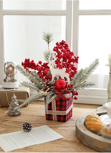 Close-up of Christmas centerpiece with Buffalo Plaid base, deer, pine cones, and LED lights