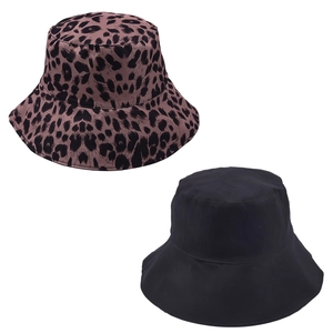 Detail of leopard print and solid black reversible cotton bucket hats for outdoor sun protection