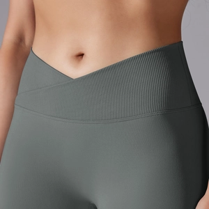 Detail of cross high waist yoga leggings with ribbed texture and seamless dark gray fabric