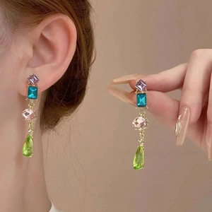 Detail view of long gold-plated drop earrings with multicolor geometric crystal beads