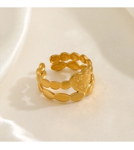 Close-up of golden stainless steel heart ring with 'for best' engraving on silk