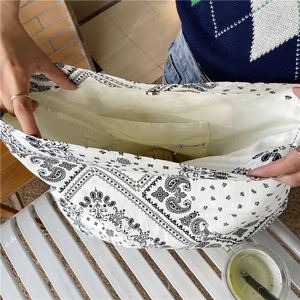 Close-up of paisley canvas tote bag interior with magnetic closure and zipper pocket