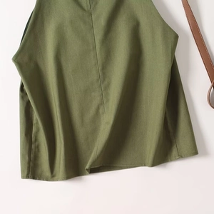 Detailed macro shot of army green linen tank top showing woven fabric texture and hem