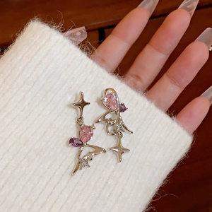 Detailed macro view of S925 silver star earrings with pink zircon and purple diamonds