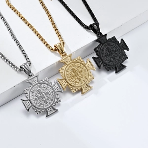 Detailed view of Saint Benedict exorcism pendants in silver, gold, and black stainless steel