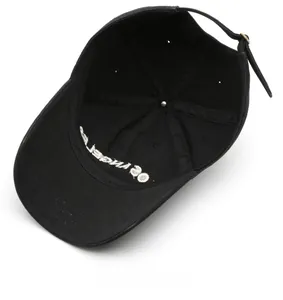Detail view of cotton baseball cap interior showing reinforced seams and metal buckle