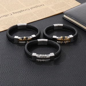 Three braided leather bracelets with stainless steel rivet magnetic clasps on leather background