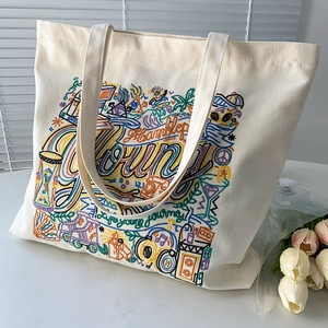 Detail shot of intricate colorful embroidery and high-quality canvas texture on a tote bag