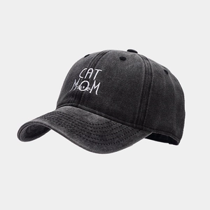 Detailed close-up of CAT MOM embroidery on charcoal grey washed cotton baseball cap