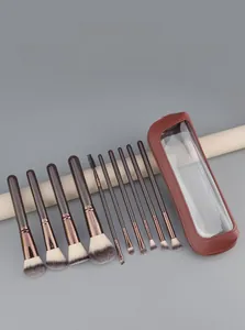 Detail of 10-piece makeup brush set with gradient bristles and brown travel storage pouch