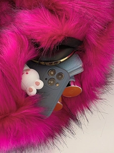 Spacious rose red faux fur shoulder bag with phone and wallet inside view