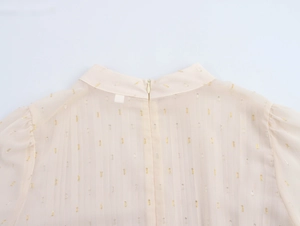 Close-up of pink chiffon dress featuring metallic gold jacquard pattern and back zipper
