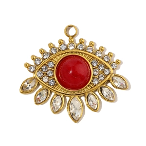 Detailed view of evil eye pendant with red gemstone and sparkling water drop crystals