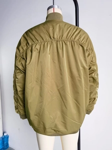 Detail of the olive green bomber jacket back with distinctive ruched stitching design