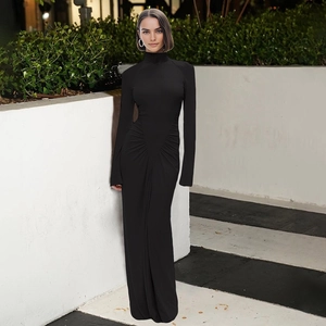 Close-up of elegant black high-neck maxi dress with ruched waist and long sleeves
