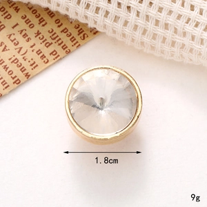 Detail shot of a 1.8cm gold-rimmed round gemstone charm for DIY jewelry and shoes