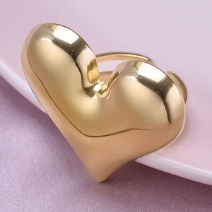 Macro shot of 18K gold plated heart ring showing polished metal texture and finish