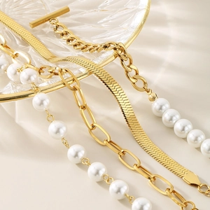 Layered gold snake chain and pearl bead bracelet set with a chic toggle clasp design