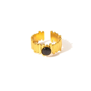 Close-up of a gold-plated titanium steel ring with a round black stone and striped band