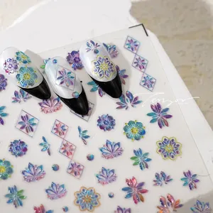 Macro detail of holographic floral and geometric nail stickers with a 3D metallic effect