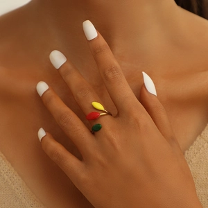 Gold-plated adjustable ring with colorful enamel leaf accents on a female model hand