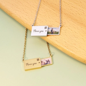 Detail view of sliding envelope pendant necklace with I love you engraving and photo