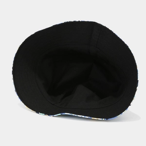 Reversible bucket hat with yellow and blue patterns and a black lining for outdoor wear