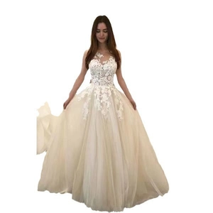 Detail showing the intricate floral lace bodice and semi-sheer mesh on ivory wedding dress
