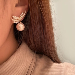 Elegant bow knot pearl drop earrings with champagne tones and sparkling zircon accents